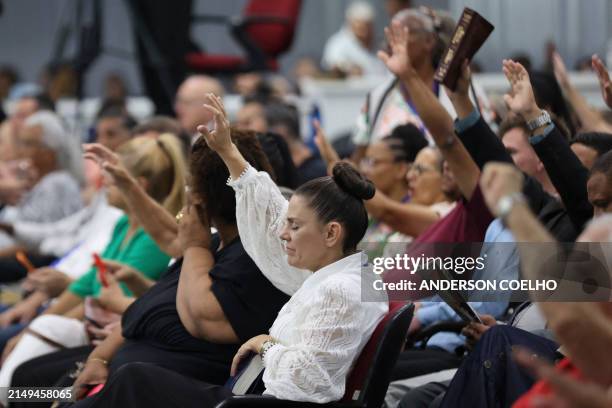 Evangelical people attend a religious service at a church in Camboriú, Santa Catarina State, Brazil, on April 23, 2024.