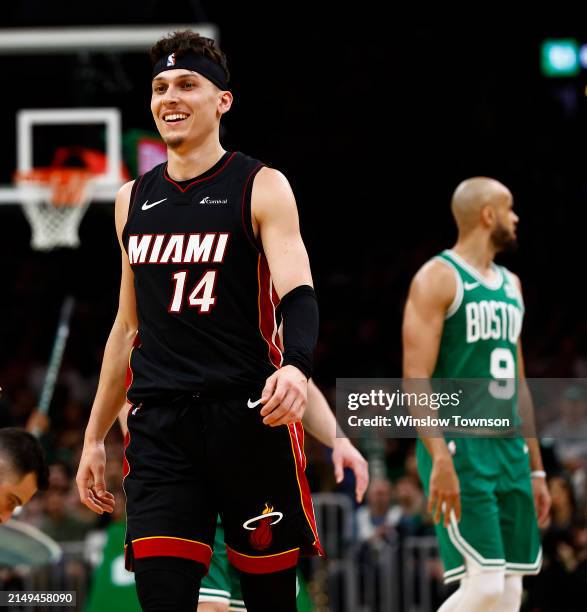 Tyler Herro of the Miami Heat smiles as Derrick White of the Boston Celtics looks towards his bench during the third quarter of game two of the...