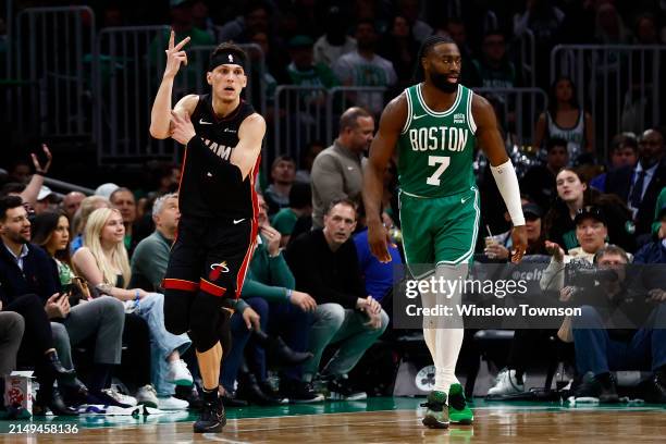Tyler Herro of the Miami Heat celebrates a three-point basket as he runs past Jaylen Brown of the Boston Celtics during the third quarter of game two...