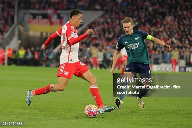 Jamal Musiala of FC Bayern München and Martin Odegaard of Arsenal FC compete for the ball during the UEFA Champions League quarter-final second leg...