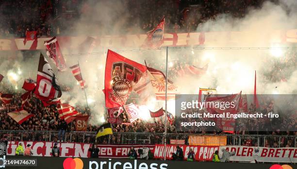 Fans of FC Bayern München ignite pyro ahead of the UEFA Champions League quarter-final second leg match between FC Bayern München and Arsenal FC at...