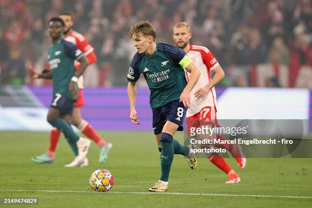 Martin Odegaard of Arsenal FC plays the ball during the UEFA Champions League quarter-final second leg match between FC Bayern München and Arsenal FC...