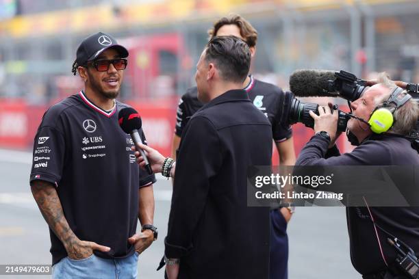 Lewis Hamilton of Great Britain and Mercedes talks to the media during the drivers parade prior to the F1 Grand Prix of China at Shanghai...