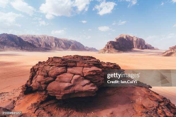 isolated rock formation amidst the desertscape of wadi rum, jordan - cliff stock pictures, royalty-free photos & images