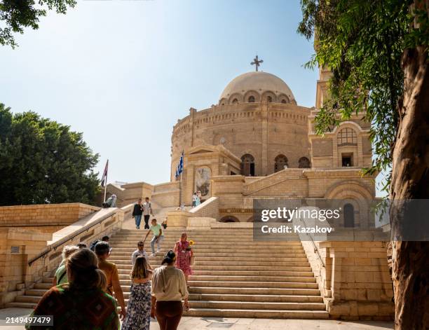 tourists in front of the coptic orthodox church of st. george in cairo city - cristianismo cóptico imagens e fotografias de stock