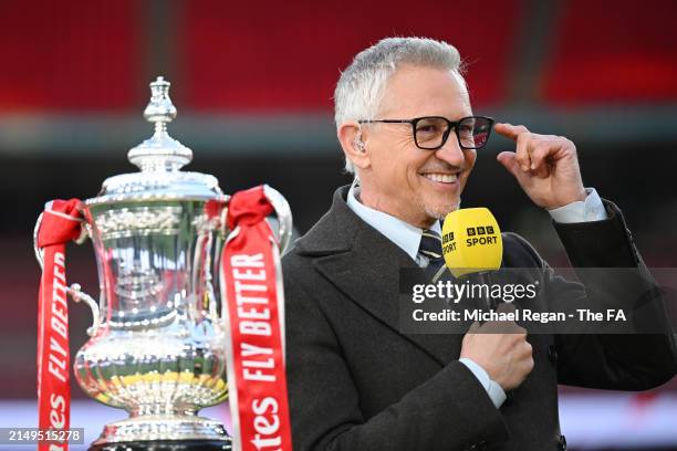 Presenter Gary Lineker looks on with the FA Cup trophy after the Emirates FA Cup Semi Final match between Manchester City and Chelsea at Wembley...