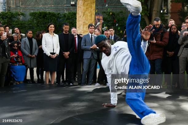 Danis Civil aka France's B-boy Dany Dann performs in front of France's Minister for Sports and Olympics Amelie Oudea-Castera , French President of...