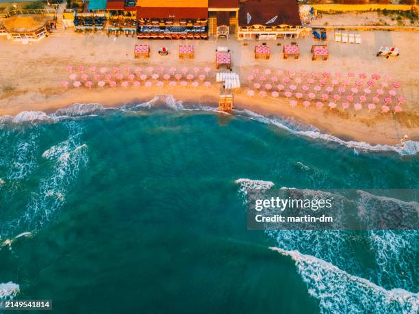 drone point of view of small beach with sunshades - black sea stock pictures, royalty-free photos & images
