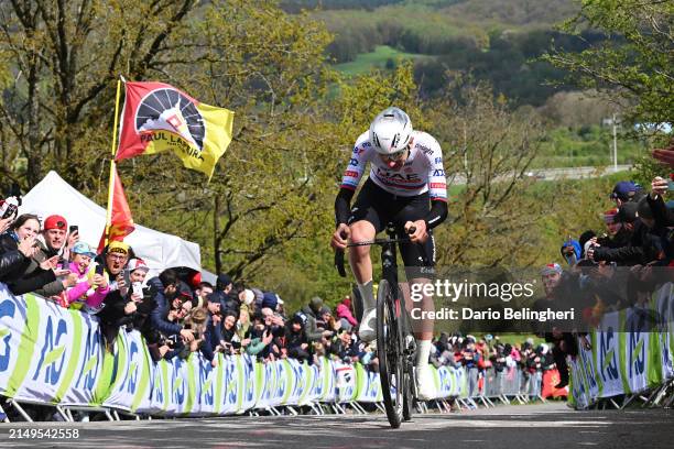 Tadej Pogacar of Slovenia and UAE Team Emirates attacks in the Côte de La Redoute while fans cheer during the 110th Liege - Bastogne - Liege 2024,...