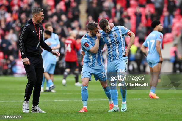 Ben Sheaf of Coventry City is consoled by teammate Matthew Godden after the team's defeat in the penalty shoot out during the Emirates FA Cup Semi...