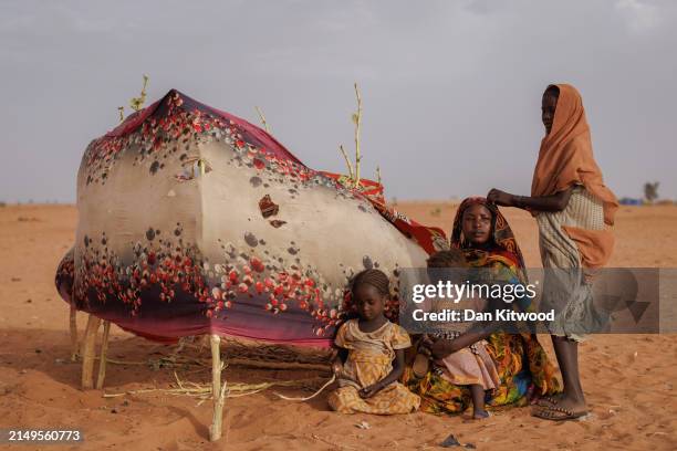 Newly arrived refugees stand outside their makeshift shelter as a sand storm approaches on April 21, 2024 in Adre, Chad. Since the beginning of the...