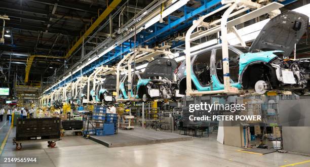 Workers continue vehicle assembly shortly before the line was shut down for an event at the Honda of Canada Manufacturing Plant 2 in Alliston,...