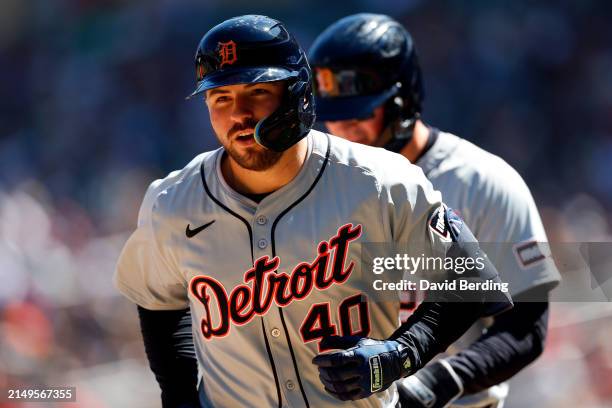 Buddy Kennedy of the Detroit Tigers reacts to his two-run home run after crossing home plate against the Minnesota Twins in the third inning at...