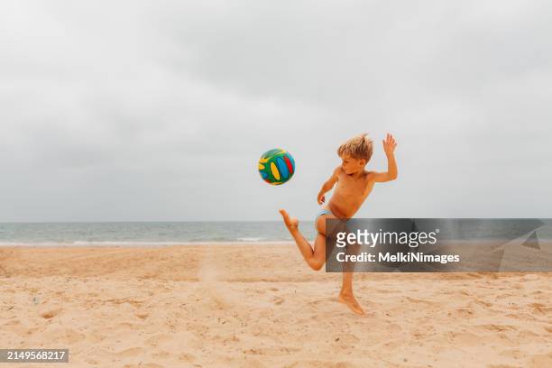 talented boy at the beach - kicking sand stock pictures, royalty-free photos & images