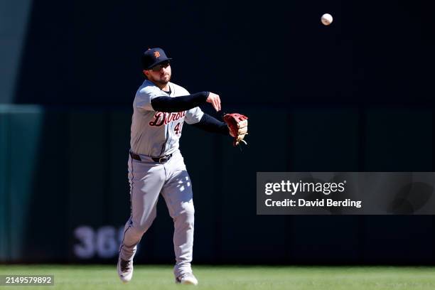 Buddy Kennedy of the Detroit Tigers throws the ball to first base to get out Edouard Julien of the Minnesota Twins in the seventh inning at Target...