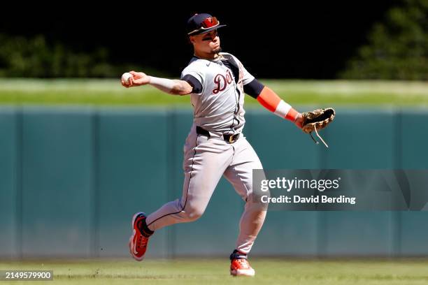 Javier Báez of the Detroit Tigers throws the ball to first base to get out Kyle Farmer of the Minnesota Twins in the seventh inning at Target Field...