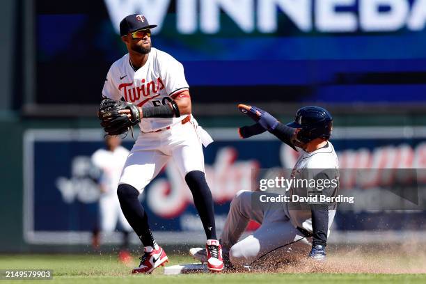 Willi Castro of the Minnesota Twins fields the ball at second base for a force out agianst Buddy Kennedy of the Detroit Tigers on a fielder's choice...