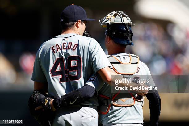Alex Faedo and Jake Rogers of the Detroit Tigers celebrate their victory against the Minnesota Twins after the game at Target Field on April 21, 2024...