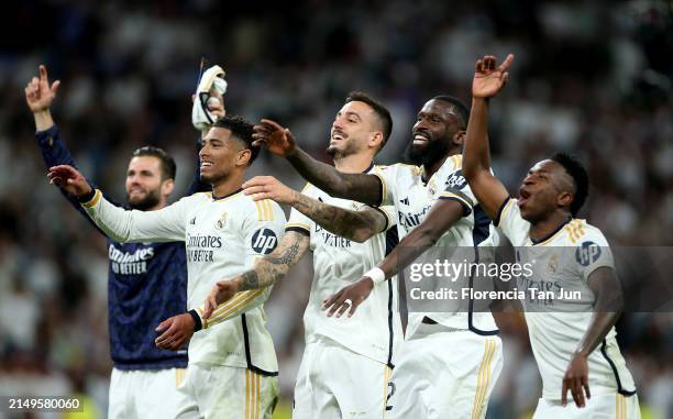 Jude Bellingham, Joselu, Antonio Ruediger and Vinicius Junior of Real Madrid celebrate at full-time following the team's victory in the LaLiga EA...