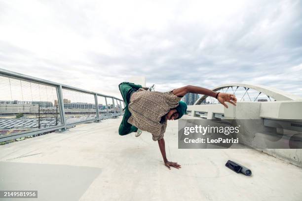 young man breakdancing in the city streets - hiphop stockfoto's en -beelden