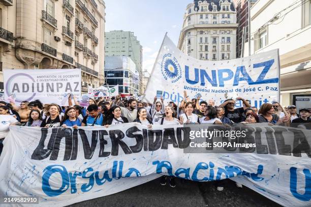 Group of protesters seen marching towards Plaza de Mayo carrying a banner during the rally. Protesters in favor of public and free education are...
