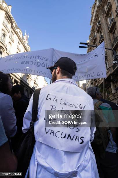 Young doctor seen with inscriptions on his back saying "in the public university we make vaccines" during the rally. Protesters in favor of public...