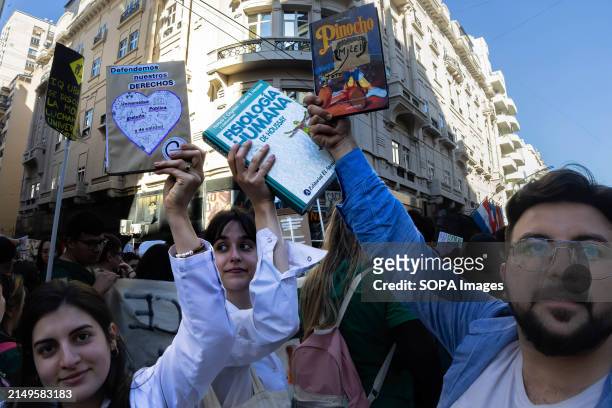 Group of young resident doctors from the University Hospital raise their books according to the slogan of the march. Protesters in favor of public...