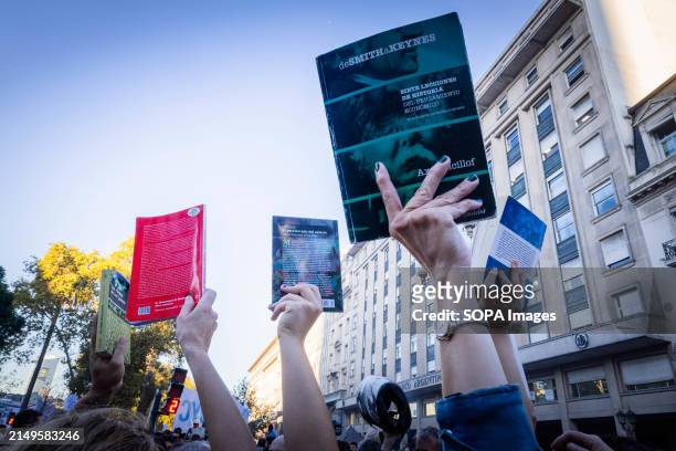 Group of demonstrators raise their books according to the march's slogan in favor of free public education during the rally. Protesters in favor of...