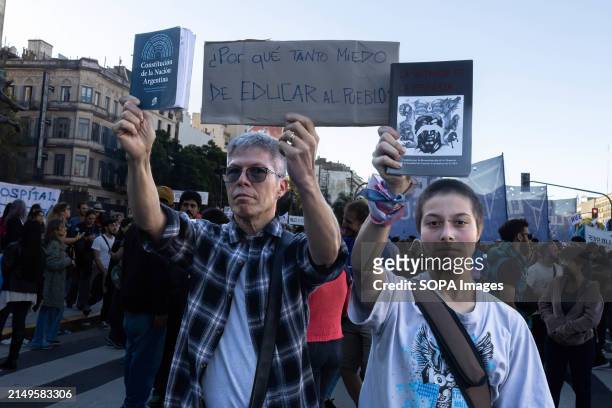 Father and son display their books according to the slogan of the march in favor of free public education. Protesters in favor of public and free...