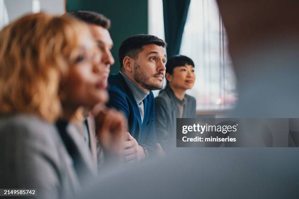 a happy handsome businessman working with his team in the office - affärsmöte bildbanksfoton och bilder