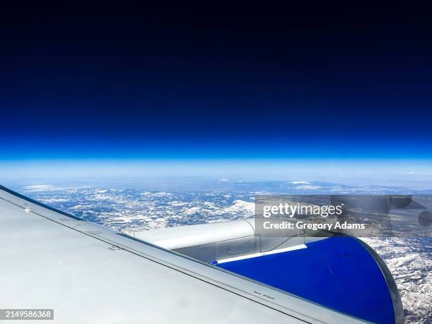 jet engine and wing above the clouds - jet engine stock pictures, royalty-free photos & images
