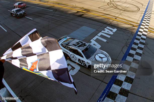Tyler Reddick, driver of the Jordan Brand Toyota, takes the checkered flag to win the NASCAR Cup Series GEICO 500 at Talladega Superspeedway on April...