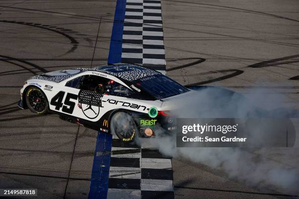 Tyler Reddick, driver of the Jordan Brand Toyota, celebrates with a burnout after winning the NASCAR Cup Series GEICO 500 at Talladega Superspeedway...