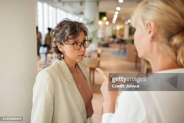 businesswoman scolding her employee - irritation stock pictures, royalty-free photos & images