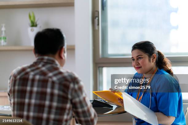 medical consultation: charting paths to wellness - nurse charting stock pictures, royalty-free photos & images