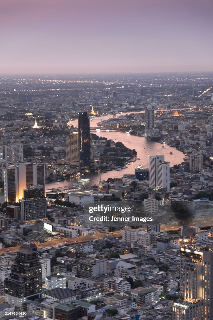 Elevated view of Bangkok city skyline at dusk.