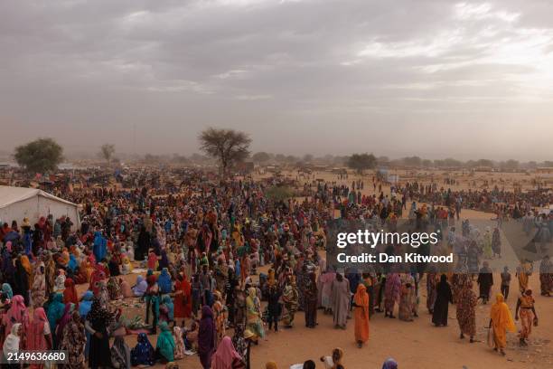 Refugees, mostly women and children wait for a WFP food distribution point to open at a temporary camp on April 22, 2024 in Adre, Chad. Since the...