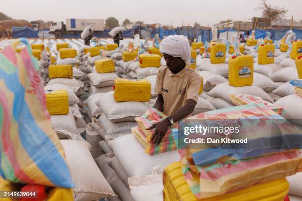 Aid is laid out ready to hand out to refugees at a WFP food distribution point to open at a temporary camp on April 22, 2024 in Adre, Chad. Since the...