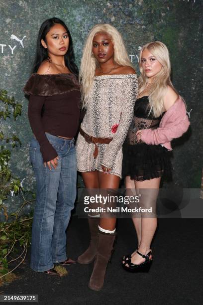 Ysabelle Salvanera, Amelia Onuorah, and Madeleine Haynes from Say Now attend the FENTY x PUMA Creeper Phatty Earth Tone Launch Party at Tobacco Dock...