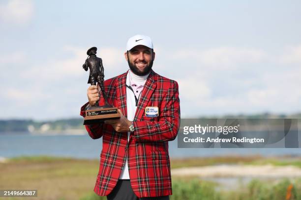Scottie Scheffler of the United States celebrates with the trophy and the tartan jacket after winning during the continuation of the final round of...
