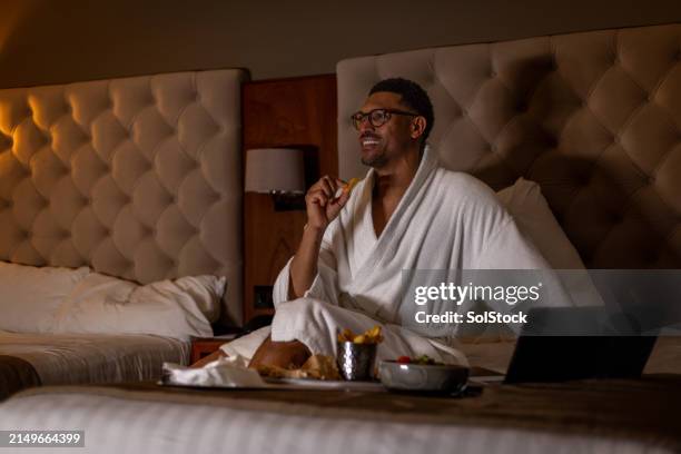 enjoying room service with some television - room service stock pictures, royalty-free photos & images