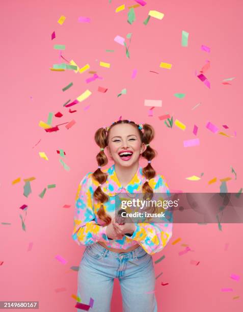 gen z young woman with stylish hairstyle among confetti - confeti pattern stock pictures, royalty-free photos & images