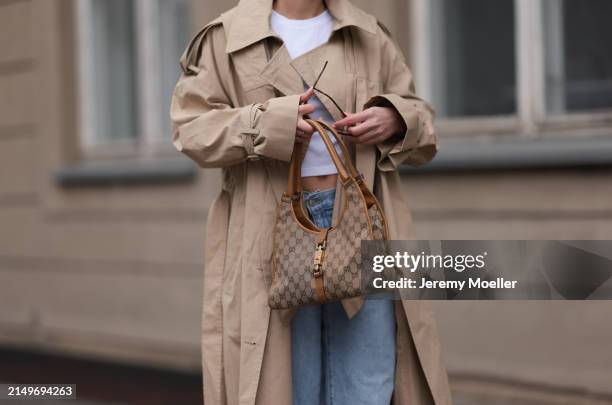 Sophia Geiss seen wearing Uniqlo white cotton basic cropped shirt, Levi's light blue denim / jeans pants, COS beige oversized long coat / trenchcoat,...