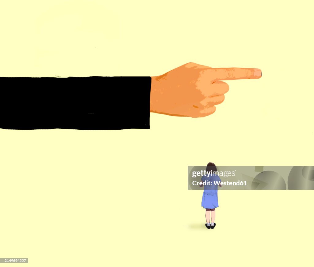 Girl looking at oversized pointing finger against yellow background