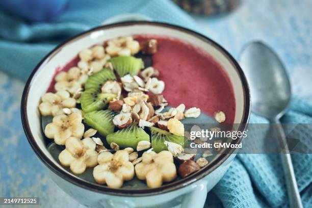 pitaya smoothie in bowl with kiwi, banana, blueberries and superfoods on top - superfood stock pictures, royalty-free photos & images