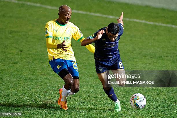 Sundowns' South African defender Khuliso Mudau fights for the ball with Esprerance's Tunisian midfielder Houssem Tka during the CAF Champions League...
