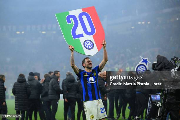 Hakan Calhanoglu of FC Internazionale celebrates winning the 2024 Scudetto championship title, after the Serie A TIM match between AC Milan and FC...