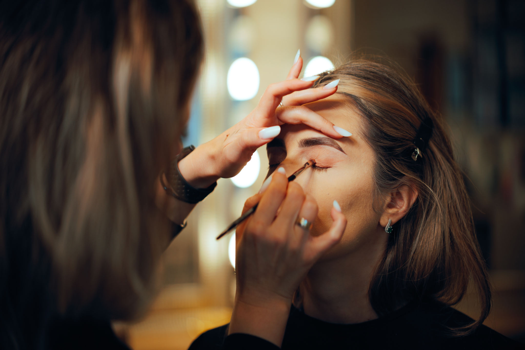 Professional Make-up Artist Applying Eyeshadow with a Brush Professional Make-up Artist Applying Eyeshadow with a Brush