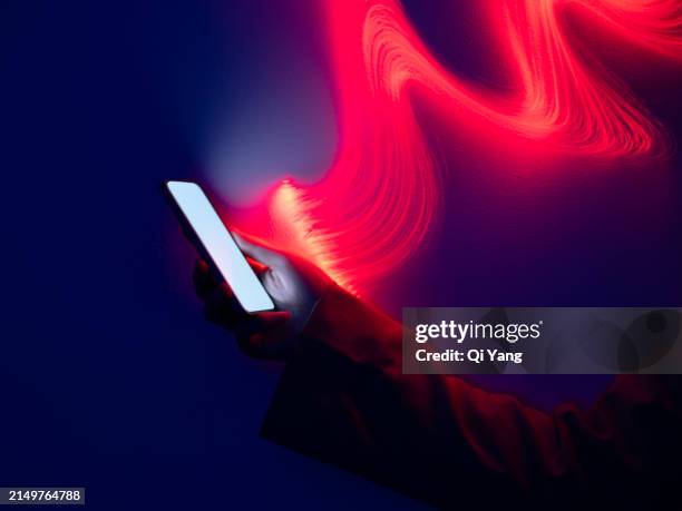 fiber optic long exposure, close-up using smartphone - mobile phone neon glow stock-fotos und bilder