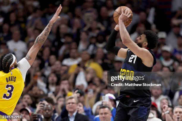 Jamal Murray of the Denver Nuggets puts up a last second shot against Anthony Davis in the fourth quarter to defeat the Los Angeles Lakers during...
